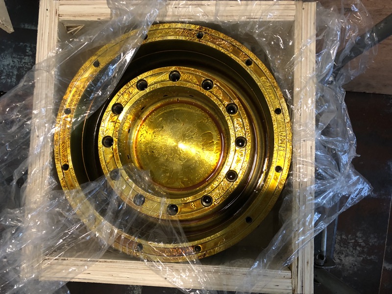 Piston crown in wooden crate